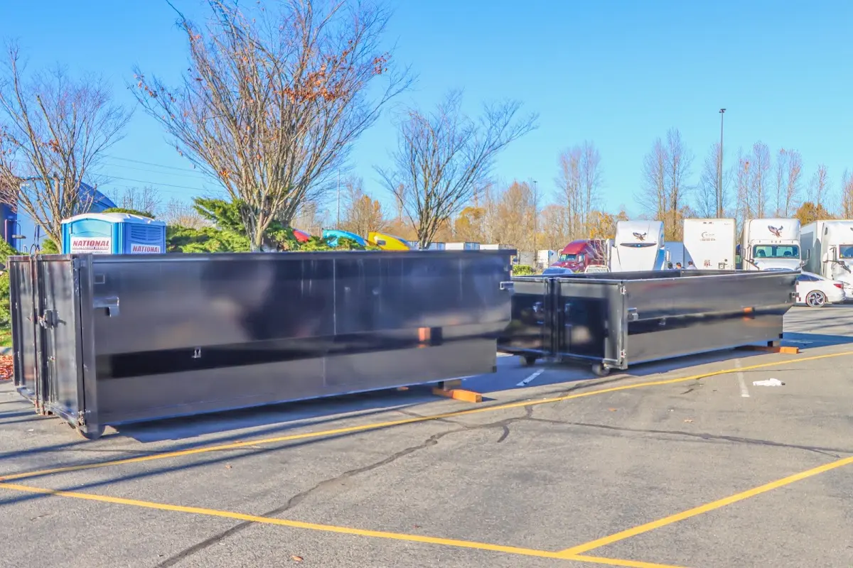 Professional dumpster rental service with roll-off container on residential driveway in Baldwinsville